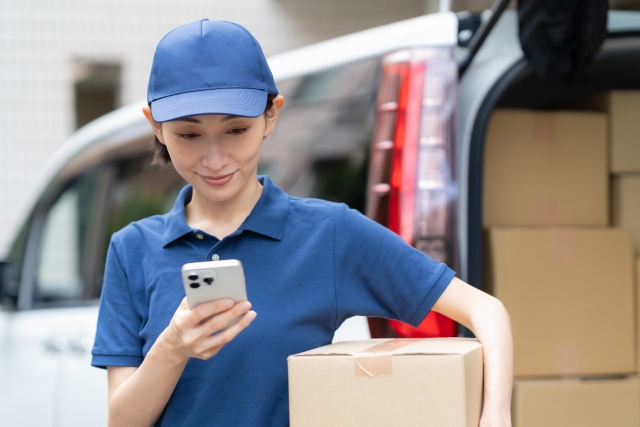 車で荷物を配達する女性配達員